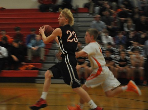 Tanner Carlson drives to the basket in a game against Lake City