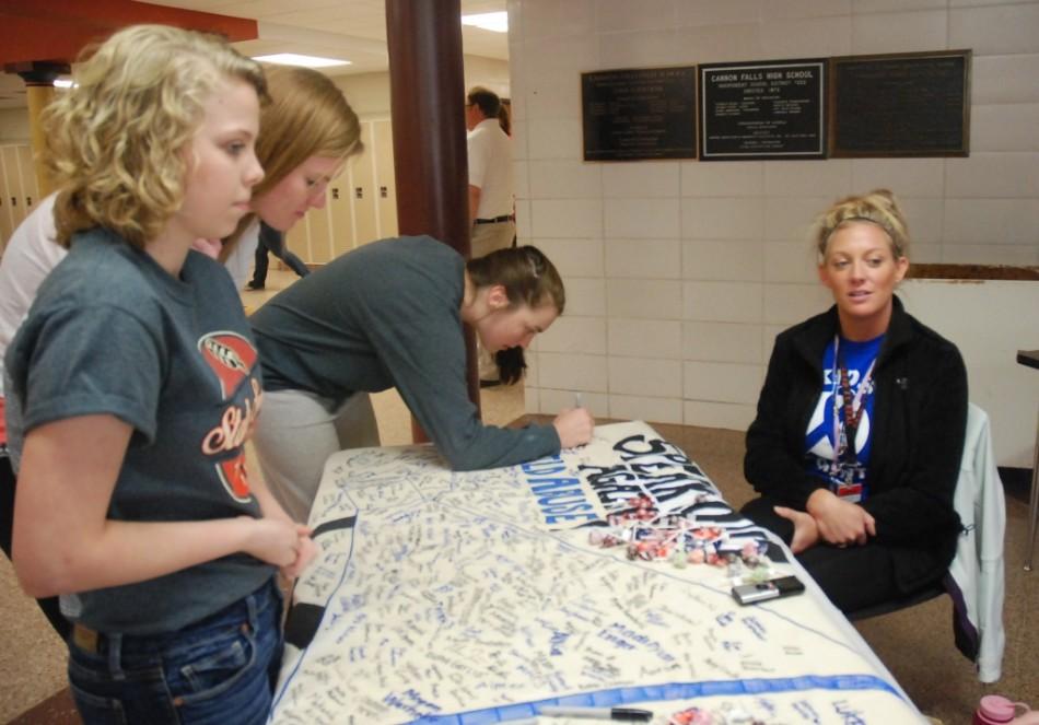 Students sign their support for Child Abuse Awareness month