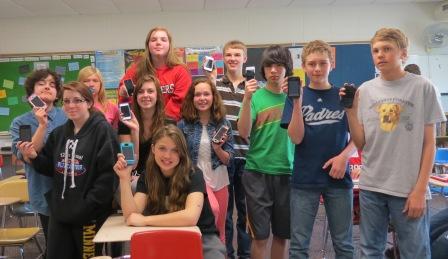 8th grade students display the smartphones requested by the String Peace Club