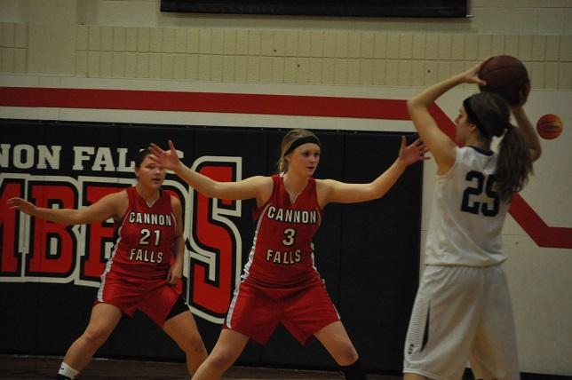 Grace Rutter and Hailey Huseth defend their basket