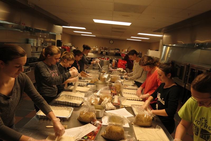 Humanities students put together pans of baklava for the annual dinner