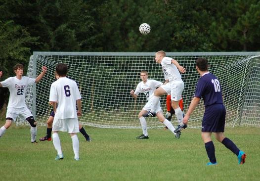 A Cannon Falls defender heads the ball away