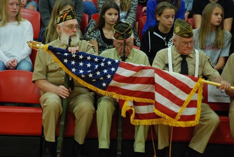 Local veterans display the colors during the Veterans day assembly