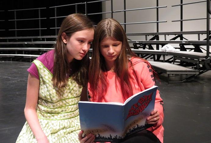 Emily Wojahn and Emma Shepersky look over their lines in anticipation of the performances of Bye Bye Birdie
