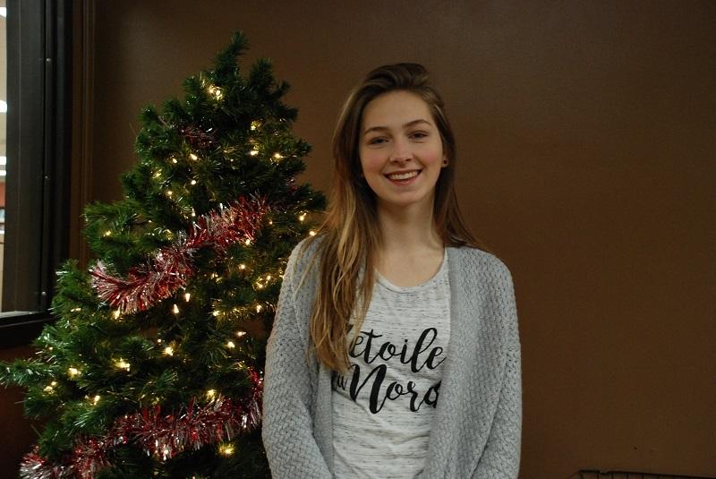 Hanna poses by a Christmas tree as she prepares to celebrate the holiday in the United States.