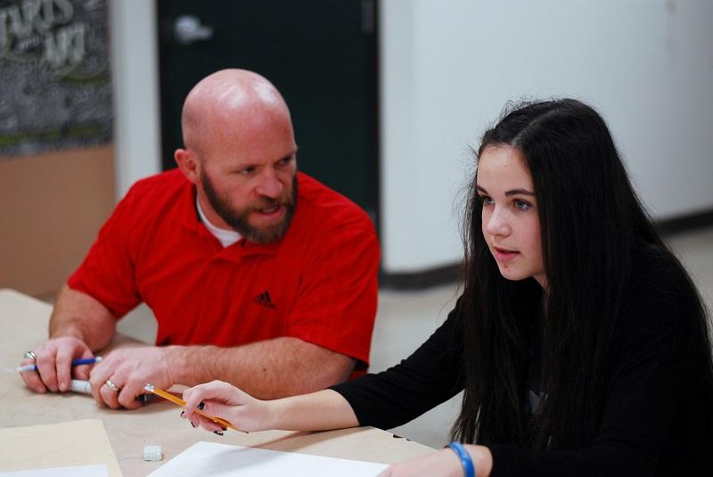 Mr. Zimmerman coaches a student to use the newly introduced techniques.