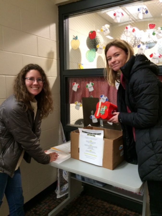 Delaine Otto and Anika Thomley give out gifts through NHS.
