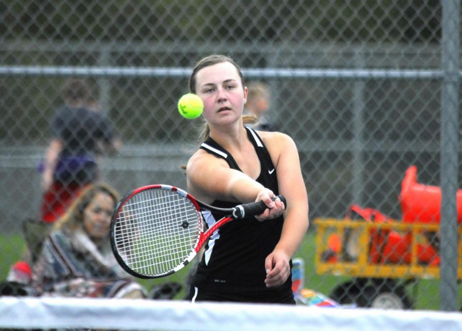 Taylor Jackson goes in to hit a forehand on the tennis teams home courts.