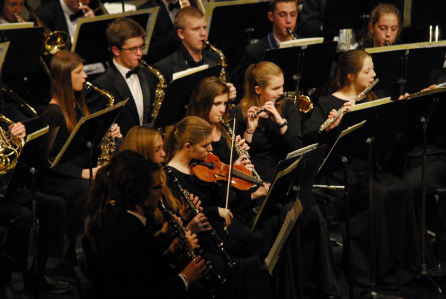 The concert band plays at their annual holiday concert in the auditorium.