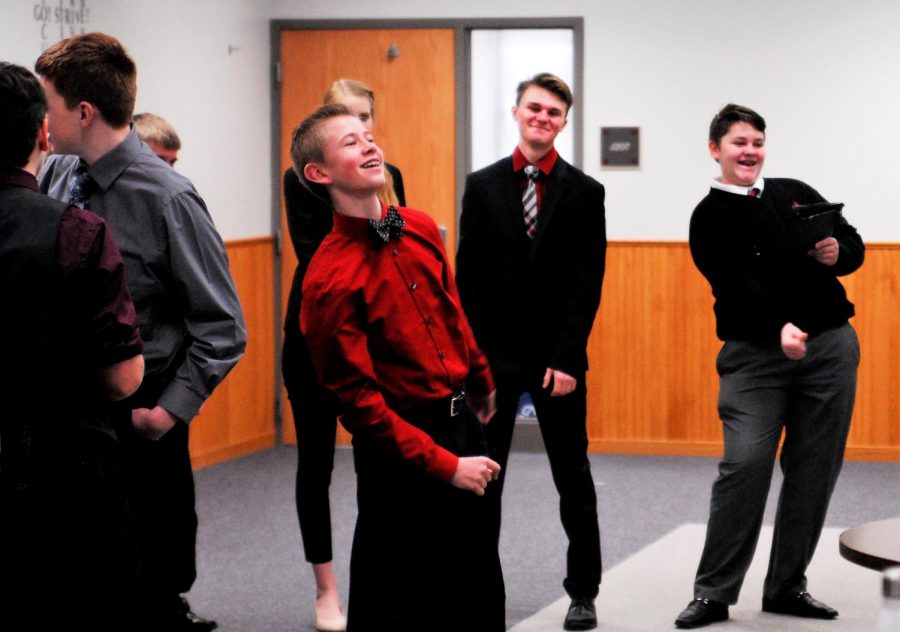 Sophomore, Ryan Schlichting, participates in warm ups with the team before a speech tournament.