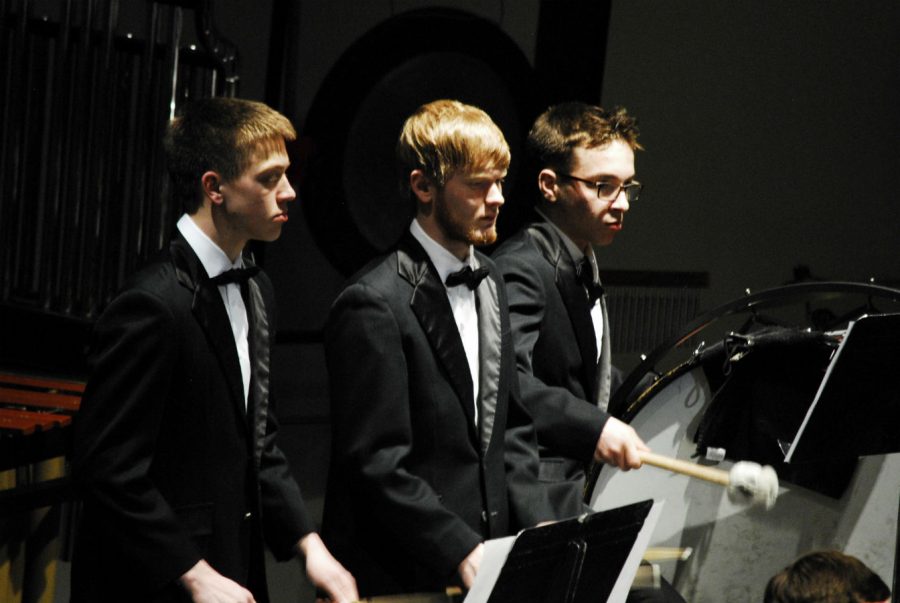 Percussionists+focus+on+their+piece+during+the+March+band+concert.