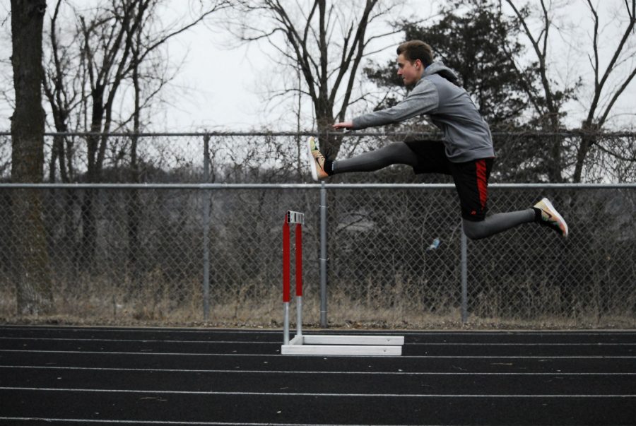 Bryson Felton practicing hurdles outside once the snow has finally melted.
