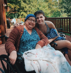 Emma Conway and Cathy Belhumer sitting on a deck at a cabin in Hayward, Wisconsin.
