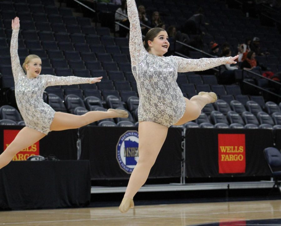 Lexie Banitt and Alison Larson leaping