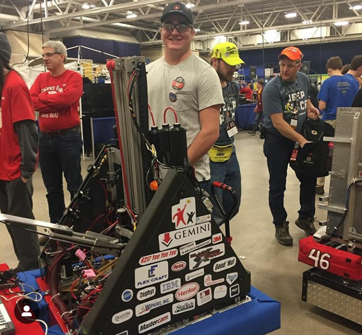 Robotics teammate Luke Langdon at the competition with the teams bomb bot.