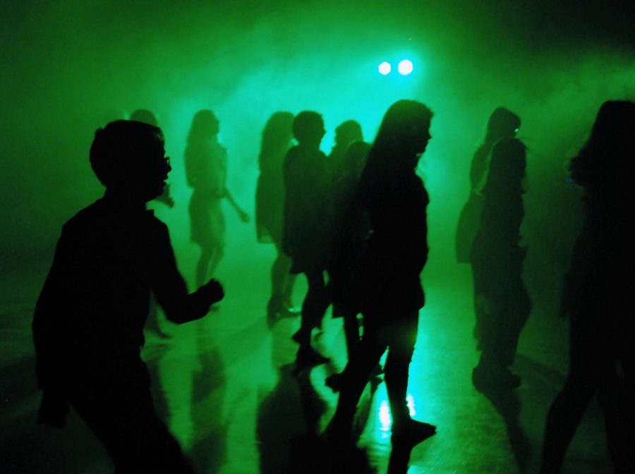 The middle school dance had many cool lights and fog that spread around the dance floor