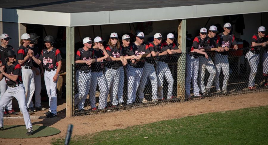 Teammates line up to watch the game unfold