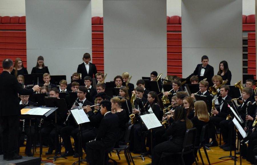 Mike legvold directs the high school band during an evening full of musical performances.