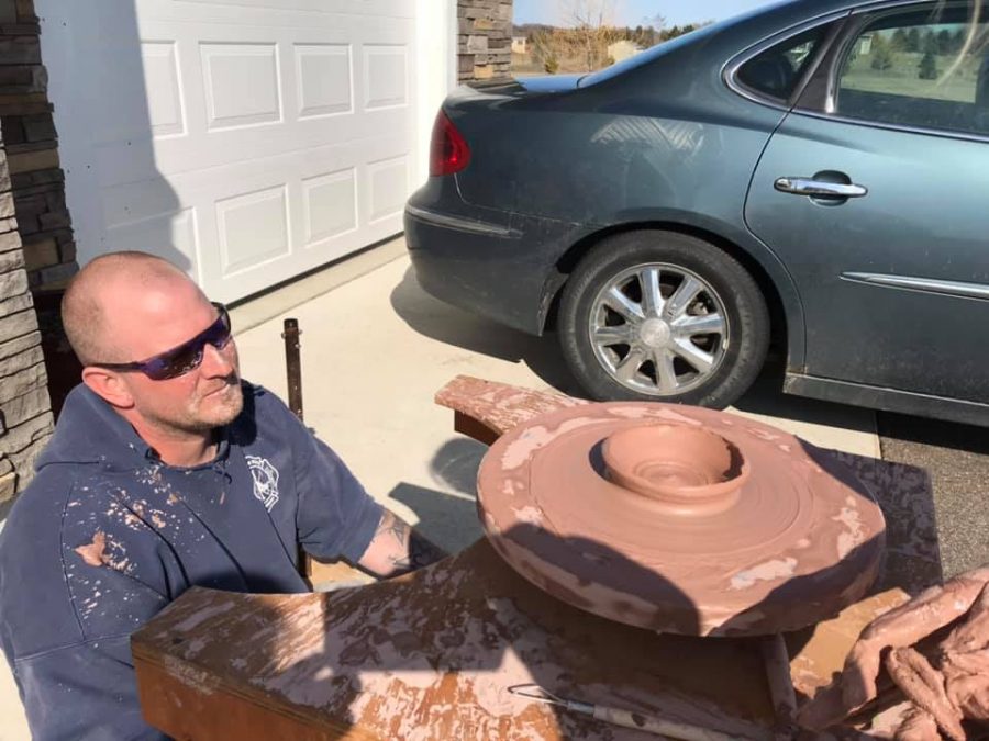 Ryan Qualey helps his daughter, Amelia Qualey, adapt to the pandemic by building her a ceramics wheel for her art classes.