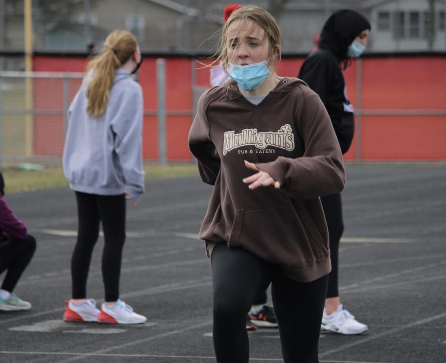 Senior Anna Becker pushes through the end of a speedy lap around the track.