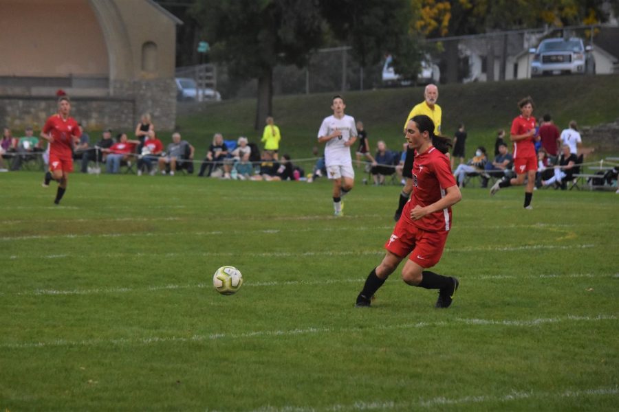 Mitch Hoffman, a senior on the boys soccer team, runs to steal the ball.