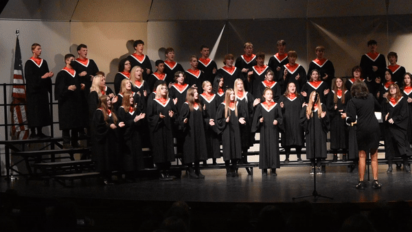 The high-school choir claps at the end of their last arrangement titled Walk in Jerusalem.