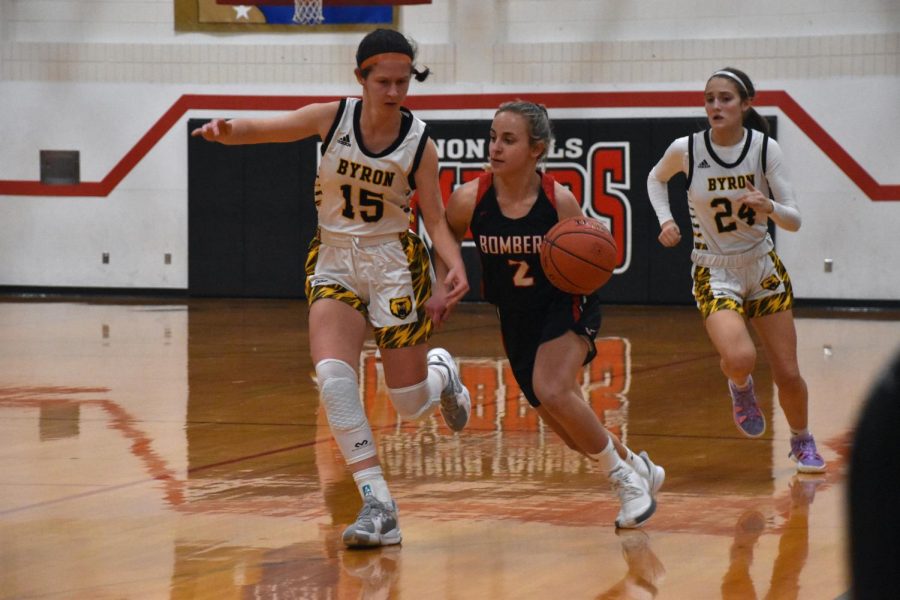 Junior guard Kyra Schoenfelder dribbles the ball down the court.