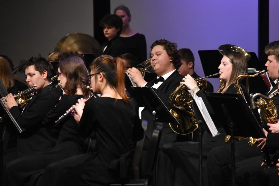 High school band students play pieces that they earned a superior rating on at contest.
