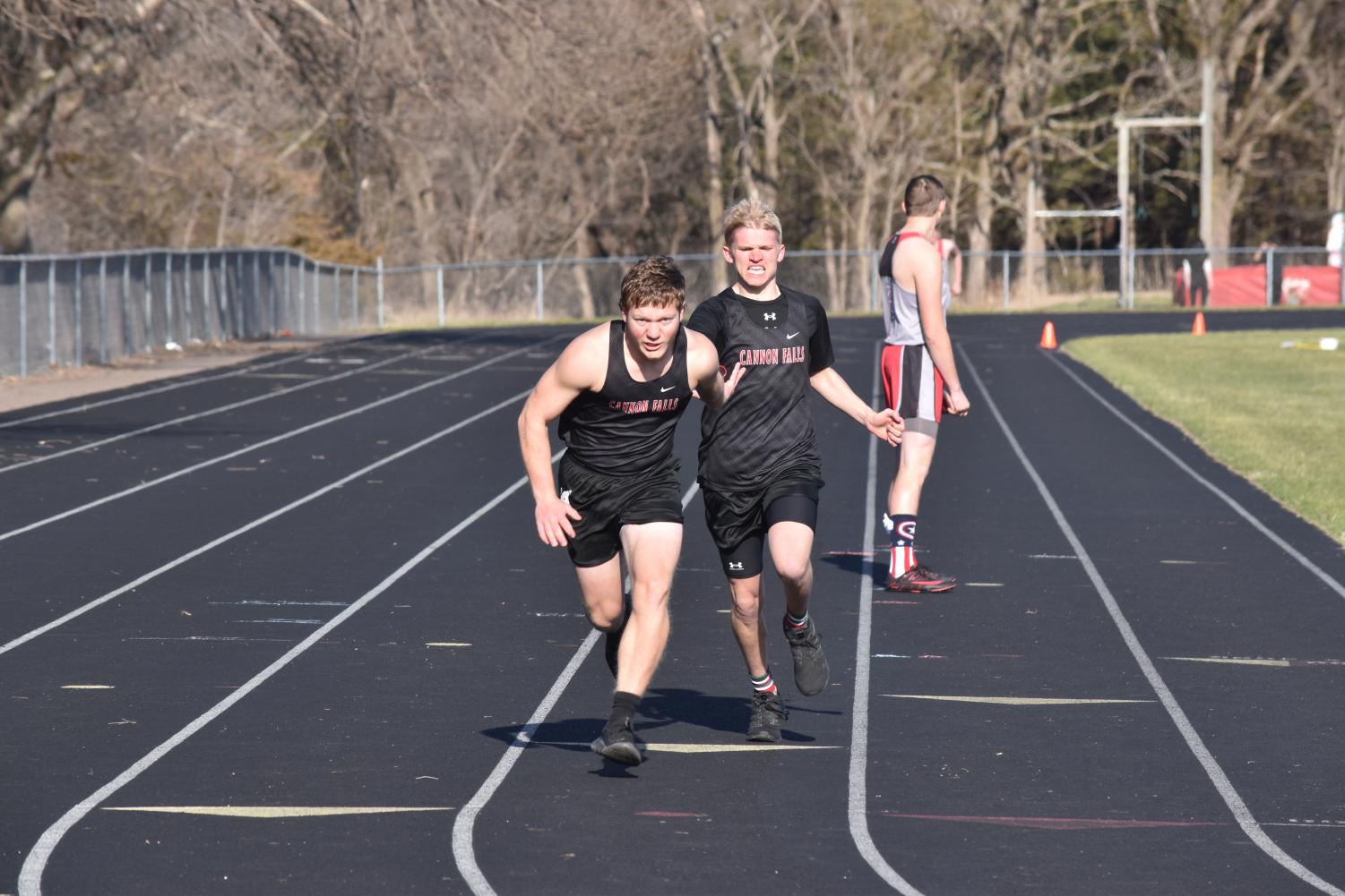Jacob Bigalk hands the baton off to Gabriel Hepola during the 4x200 meter relay. 