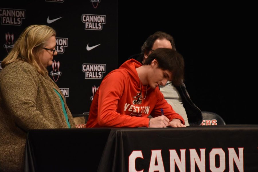 With plans to play basketball in college, Blanchard signs his contract.