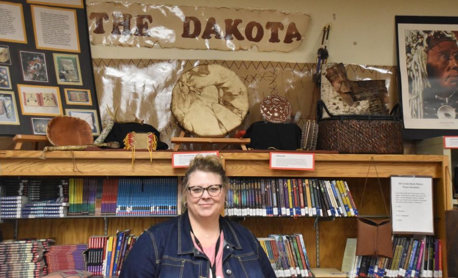 Ms Klapperich stands in front of many of the artifacts she has gathered in her classroom throughout the years