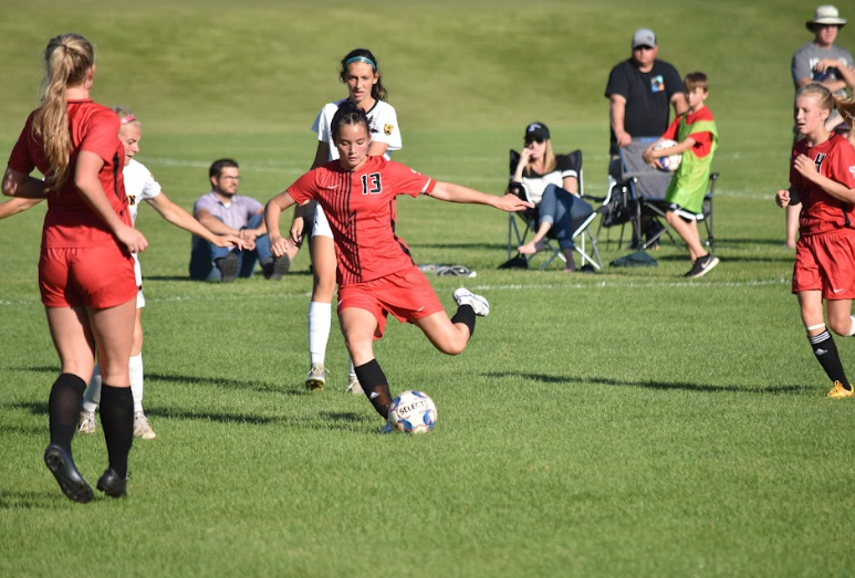 Senior Cora Park goes in for the kick 