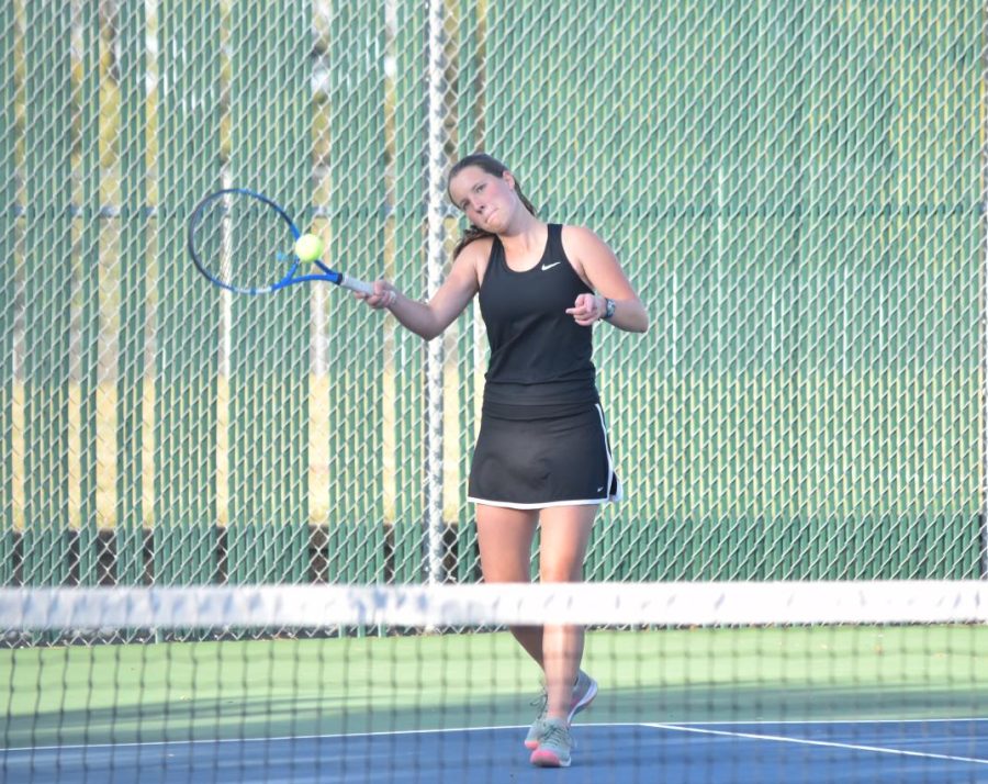 Varsity one doubles player Allison Hughes returns the tennis ball.