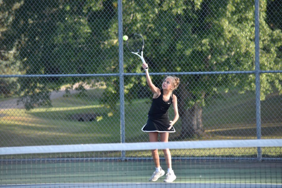 Eighth grader Livia Tennessen serves the ball during her four singles match.