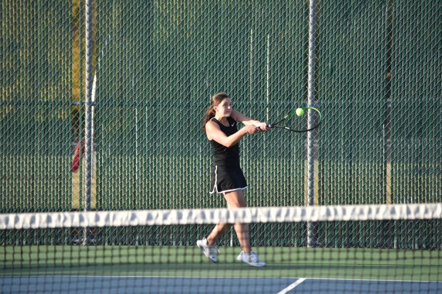 Senior Lauren Ritz hits a backhand while playing at one singles.