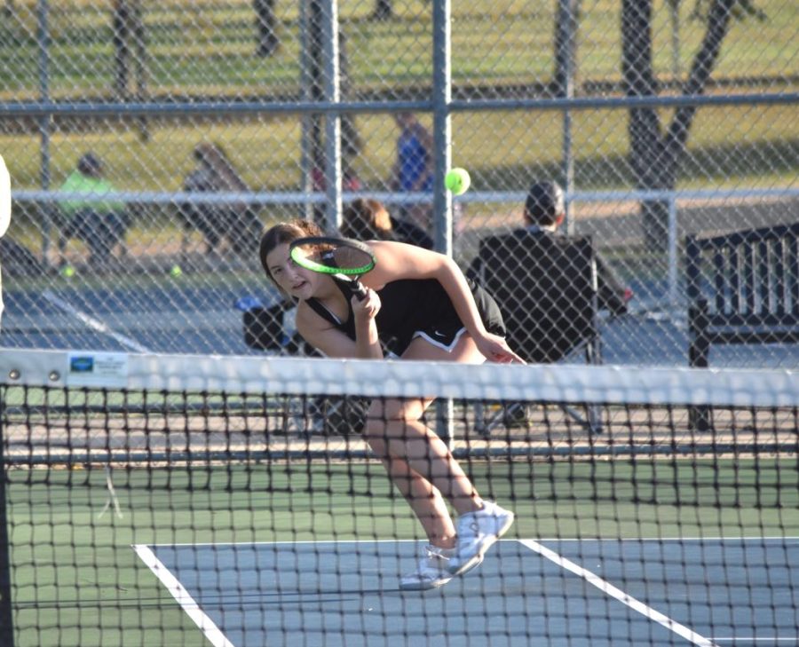 One singles player Lauren Ritz hits a forehand down the line.