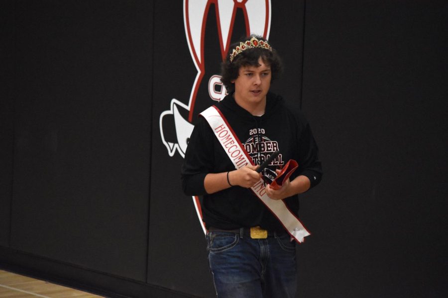 Homecoming King, Tyler Rapp plays the cowbell for the pep-band.