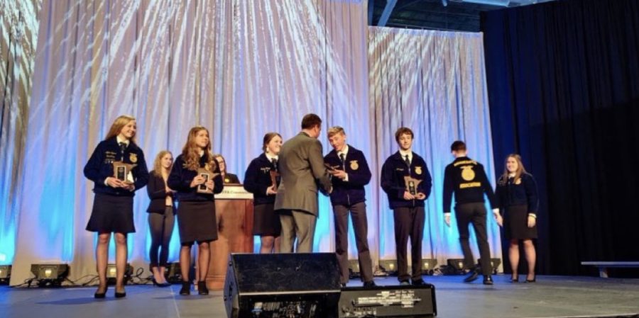 Cameron Addington accepts his first place award at state convention last April.
