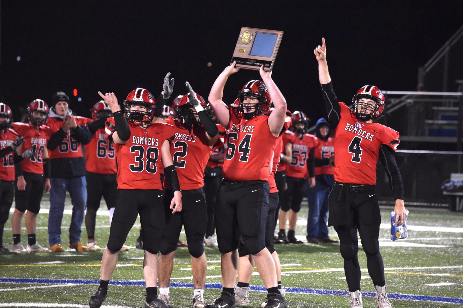 The captains of the Cannon Falls football team present their section championship award to the fans. 