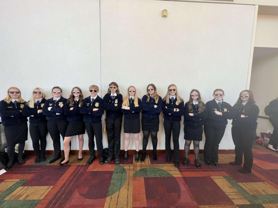 The FFA members pose outside of the convention center with their new aviator sunglasses.