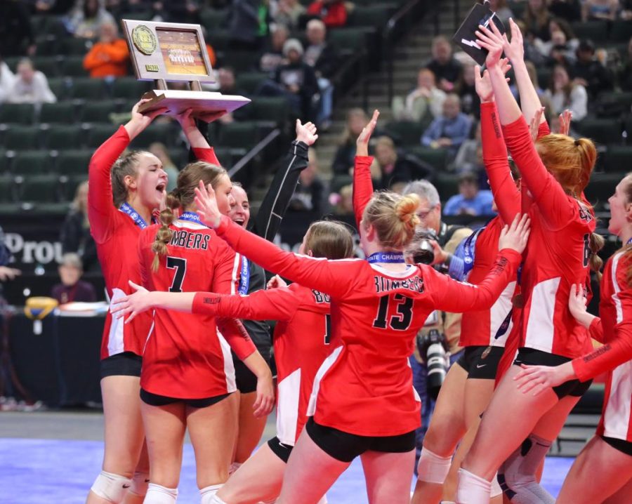 The volleyball team celebrates their win after receiving the Class 2A state championship trophy. 