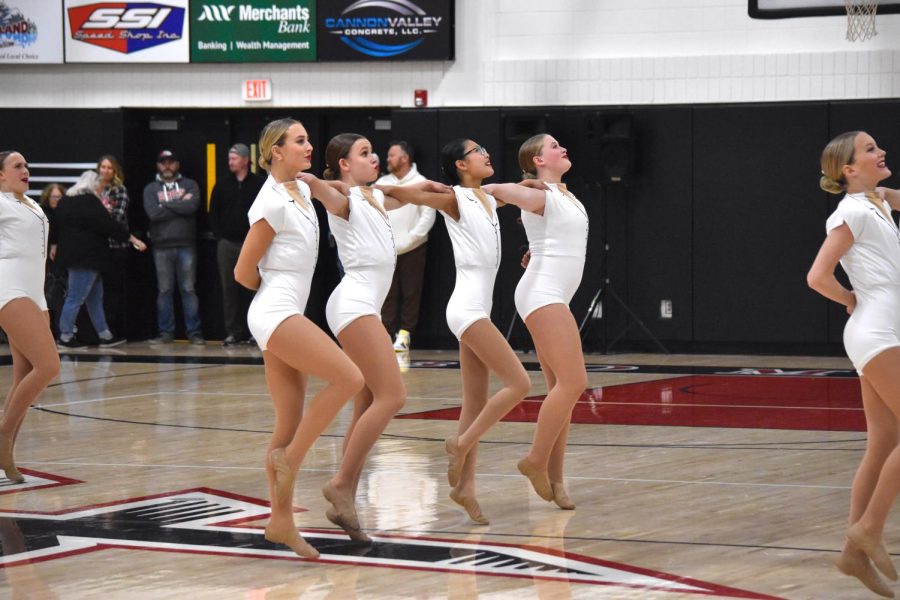 Madeline Becker, Morgan Brandel, Cindy Zheng, and Emily Breland prepare for the first set of kicks during the routine. 