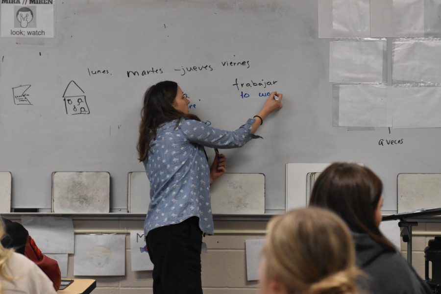 Profe Crego, as her students call her, writes on the board as she practices vocab with her students.