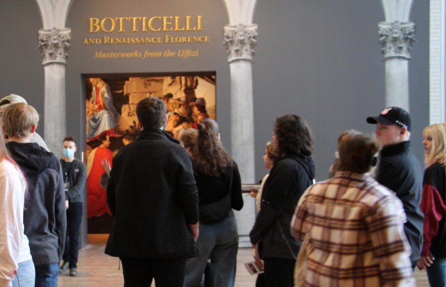 Humanities students congregate around the entrance of the Botticelli exhibit.