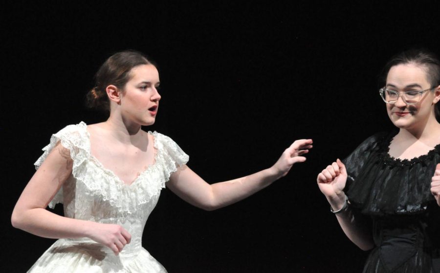 Lydia Pedersen reaches toward Paige Scherz during their community performance of the one-act play.