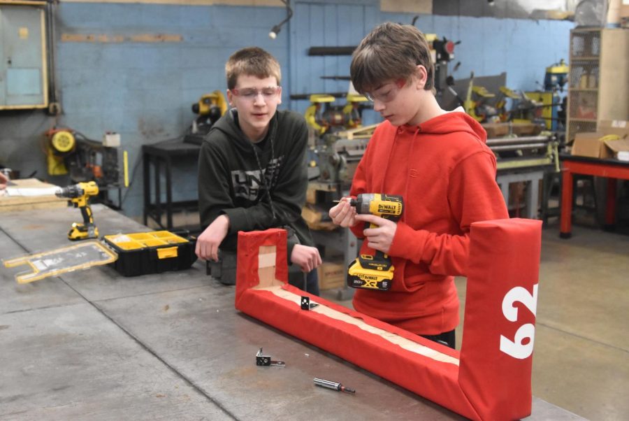 Younger team members work on the bumpers for the robot. 