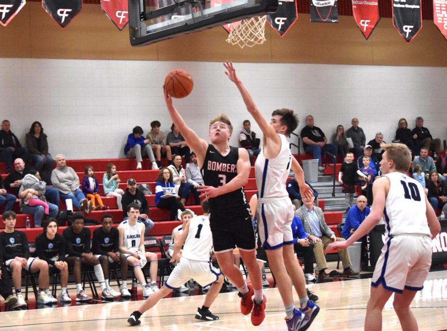 A Winona Cotter player attempts to block Dylan Bankss layup. 