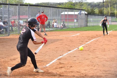 Isabelle Pagel swings the bat at a fastball. 