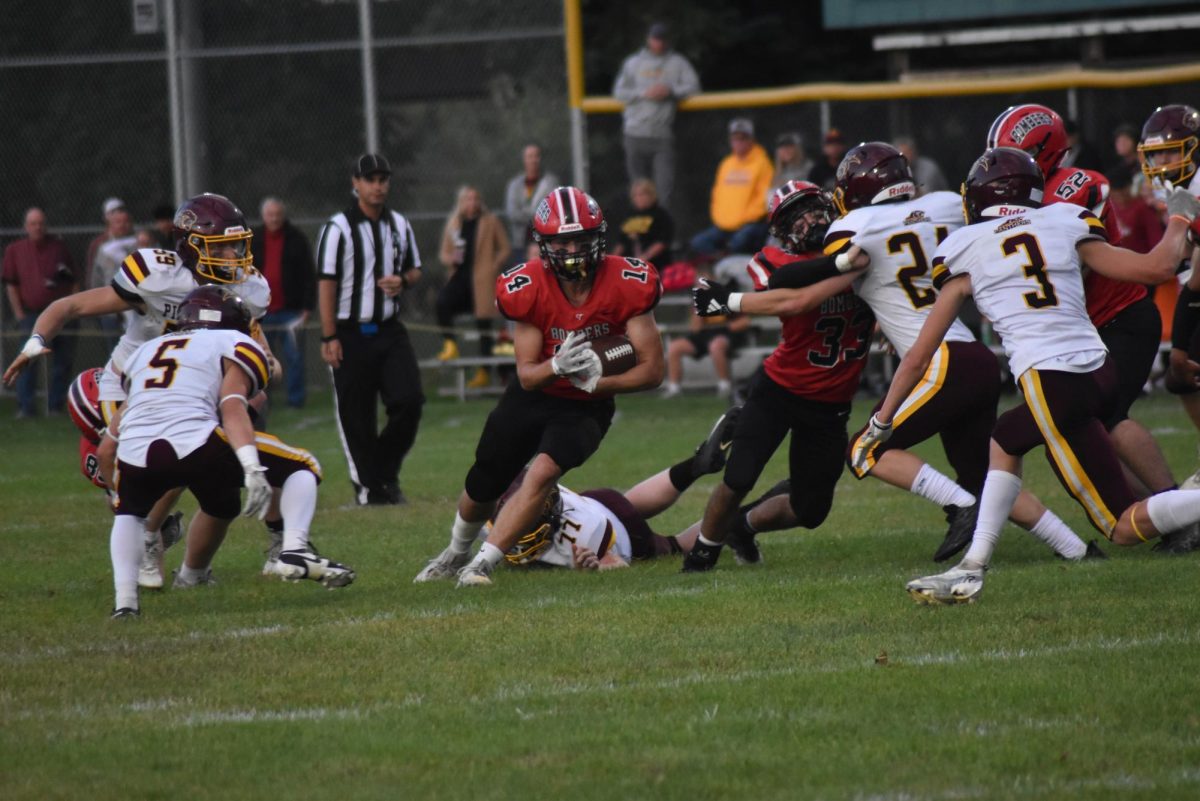 Jack Meyers runs the ball, dodging his Pine Island opponents.