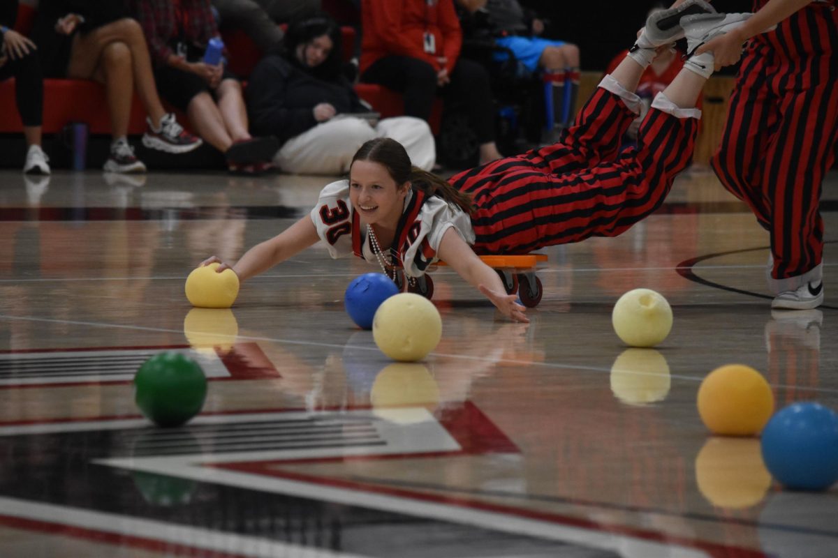 Falon Hepola zooms around the gym floor gathering foam balls in a game of Hungry Hungry Hippos.